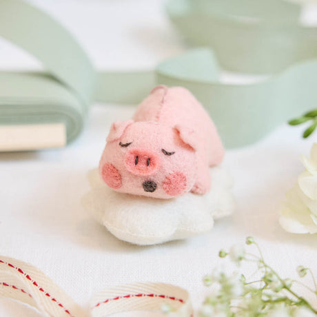 Sweet and serene, this adorable pig ornament rests peacefully on a soft cloud, capturing the gentle calm of a sleeping baby - irresistibly cute.&nbsp; With its rosy cheeks, tiny snout, and closed eyes, it brings a sense of warmth and quiet charm to any nursery or holiday setting. So cute it will make you squeal.&nbsp;