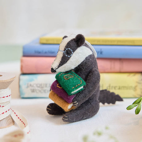 Reminiscent of Wind in the Willows, or a character from Beatrix Potter, this studious little badger is just darling! You are sure to fall in love with his cute embroidered spectacles, pile of books and just darling handcrafter details.