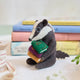 Reminiscent of Wind in the Willows, or a character from Beatrix Potter, this studious little badger is just darling! You are sure to fall in love with his cute embroidered spectacles, pile of books and just darling handcrafter details.