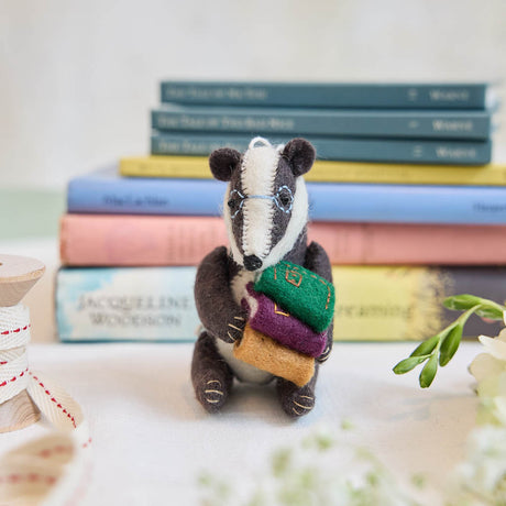 Reminiscent of Wind in the Willows, or a character from Beatrix Potter, this studious little badger is just darling! You are sure to fall in love with his cute embroidered spectacles, pile of books and just darling handcrafter details.