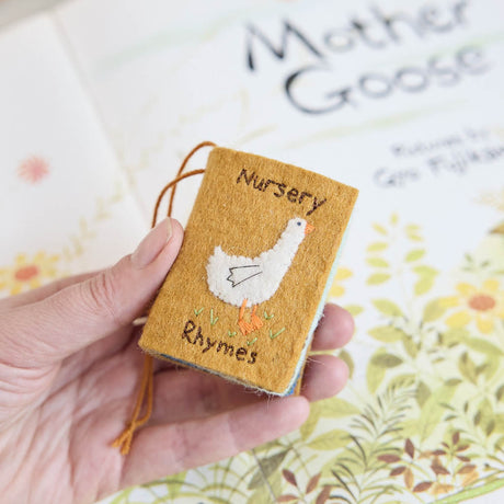 handcrafted miniature nursery rhymes book celebrating classic childhood tunes and stories, ready to hang on the tree or in the nursery!