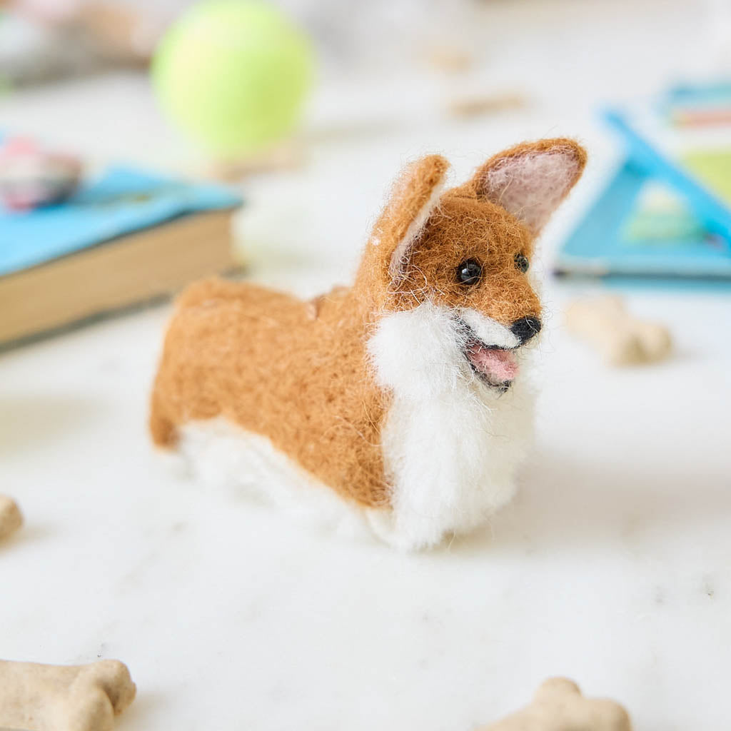 Bring a little wagging joy to your holiday decor with our irresistibly cute Felted Alpaca Corgi Ornament. Lovingly handmade by skilled artisans, this cheerful pup features the corgi’s signature golden coat, perky ears, and—of course—its famously adorable heart-shaped butt.