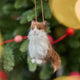 Celebrate the unique beauty of feline companions with our felt Calico Cat Ornament. Carefully handcrafted by skilled artisans, this elegant ornament features the signature patchwork of warm browns, soft whites, and golden tones that make calico cats so beloved.