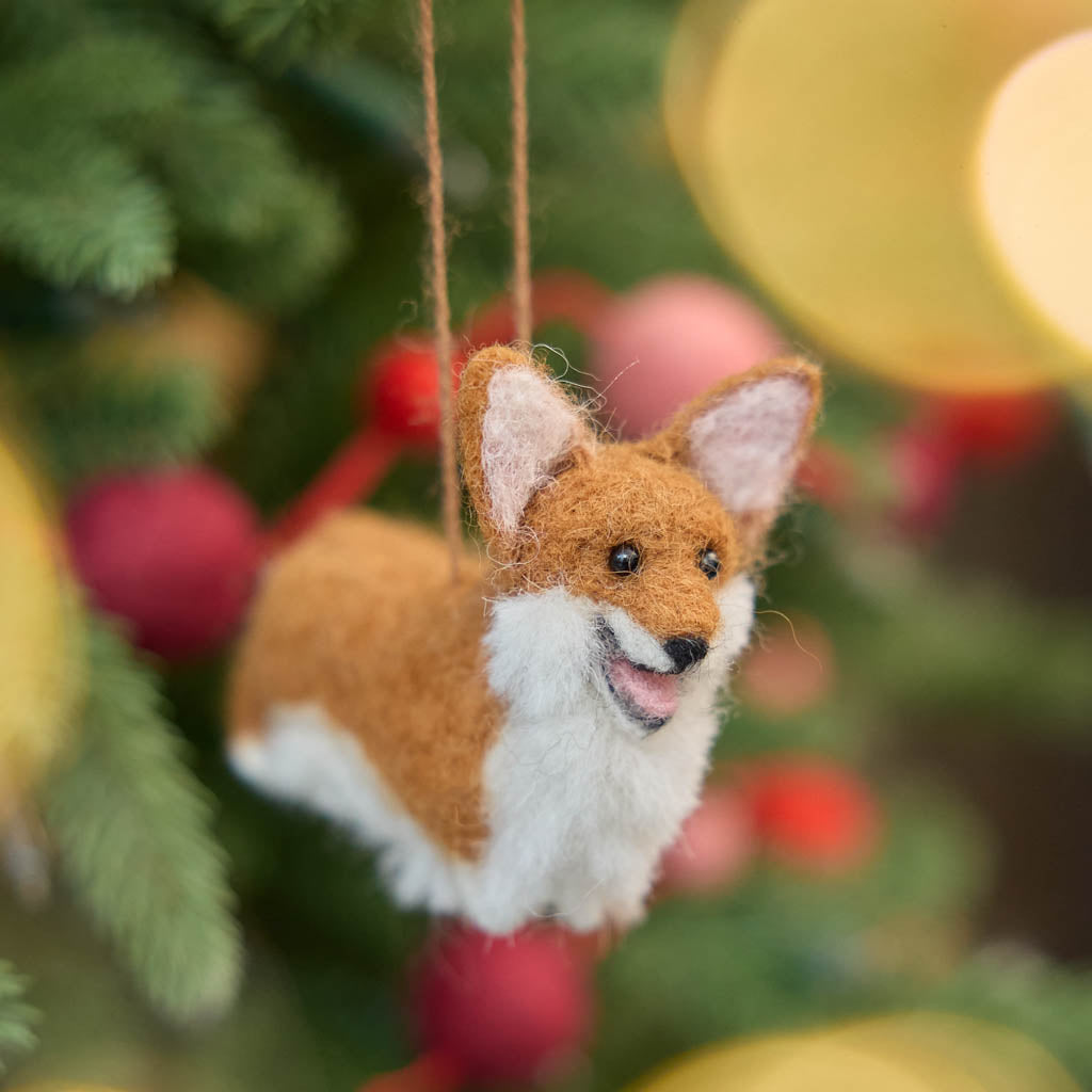 Bring a little wagging joy to your holiday decor with our irresistibly cute Felted Alpaca Corgi Ornament. Lovingly handmade by skilled artisans, this cheerful pup features the corgi’s signature golden coat, perky ears, and—of course—its famously adorable heart-shaped butt.