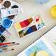 A small celebration of color in miniature form, our Paint Palette Ornament captures the familiar beauty of an artist’s workspace. Soft blocks of felted color sit alongside a tiny paintbrush with splashing embroidered brushstrokes, as if paused mid-creation.