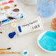 Add a splash of creativity to your holiday décor with our handcrafted Paint Tube Ornament. Designed for artists, makers, and color lovers, this charming felt ornament captures the playful essence of a classic paint tube—complete with a vibrant blue “paint” drop detail. On the back, intricate embroidery mimics a real paint label—complete with ‘Primary Blue #287’ markings and barcode-style details—adding an extra layer of realism and handcrafted charm.