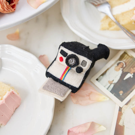 A retro-inspired felt Polaroid camera ornament that captures the joy of memories and nostalgia—perfect for photographers and meaningful gifting.