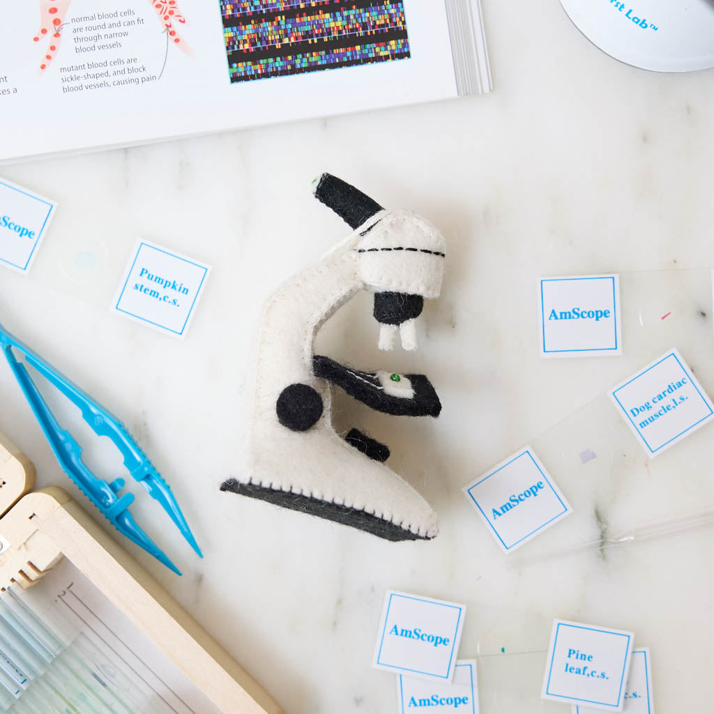 Celebrate curiosity, discovery, and the wonders of science with our handmade Felt Microscope Ornament — a charming keepsake perfect for scientists, biology lovers, teachers, researchers, lab technicians, and STEM enthusiasts.