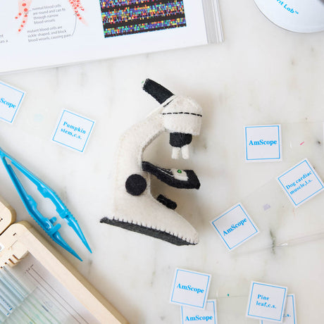 Celebrate curiosity, discovery, and the wonders of science with our handmade Felt Microscope Ornament — a charming keepsake perfect for scientists, biology lovers, teachers, researchers, lab technicians, and STEM enthusiasts.