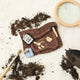 Unearth a piece of prehistoric wonder with our Felt Dinosaur Bones Ornament. Carefully handcrafted by skilled artisans using sustainable wool felt, this charming ornament features an excavation scene complete with partially uncovered dinosaur fossils, excavation tools, field notes, and scientific equipment.