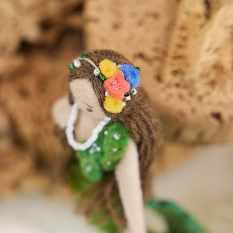 Add a touch of ocean magic to your Christmas tree with our beautiful Siren Mermaid Ornament. Lovingly handcrafted from eco-friendly wool felt, this elegant mermaid features flowing brunette hair, a vibrant green tail adorned with sparkling bead accents, and charming floral details inspired by the treasures of the sea.