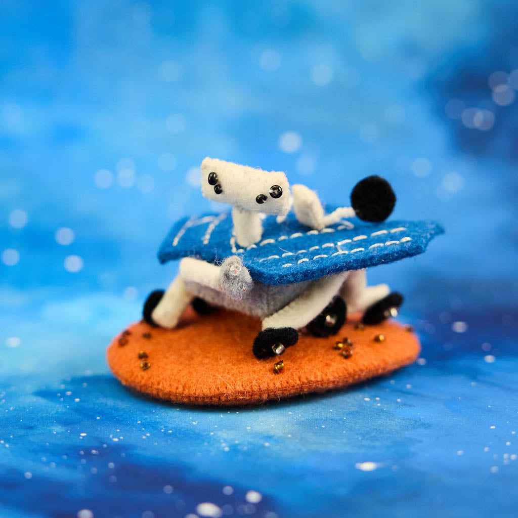 Explore the Red Planet with our handcrafted Mars Opportunity Rover Ornament, inspired by NASA’s legendary Mars Exploration Rover, affectionately known as "Oppy." Designed in soft wool felt with intricate handcrafted details, this ornament captures the iconic rover as it traverses the dusty Martian landscape in search of scientific discoveries.