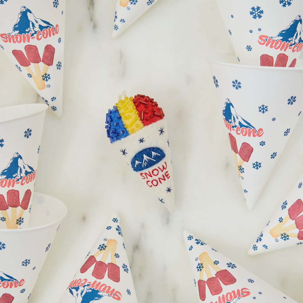Cool off your Christmas tree with our Summer Snow Cone Ornament, a cheerful felt ornament inspired by one of summer’s most iconic frozen treats. Handcrafted by skilled artisans using traditional felting techniques, this whimsical ornament features a vibrant tri-color snow cone topped with sparkling bead accents that mimic crunchy ice crystals. The detailed white cone is embroidered with classic snow cone graphics and playful lettering, capturing the carefree spirit of amusement parks, beach vacations, and s