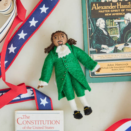 Celebrate the cultural phenomenon that brought Revolutionary history to a new generation with our handcrafted Lin-Manuel Miranda as Hamilton Ornament. Inspired by his iconic portrayal of Alexander Hamilton, this felt ornament captures the energy, creativity, and theatrical spirit of a groundbreaking American story.