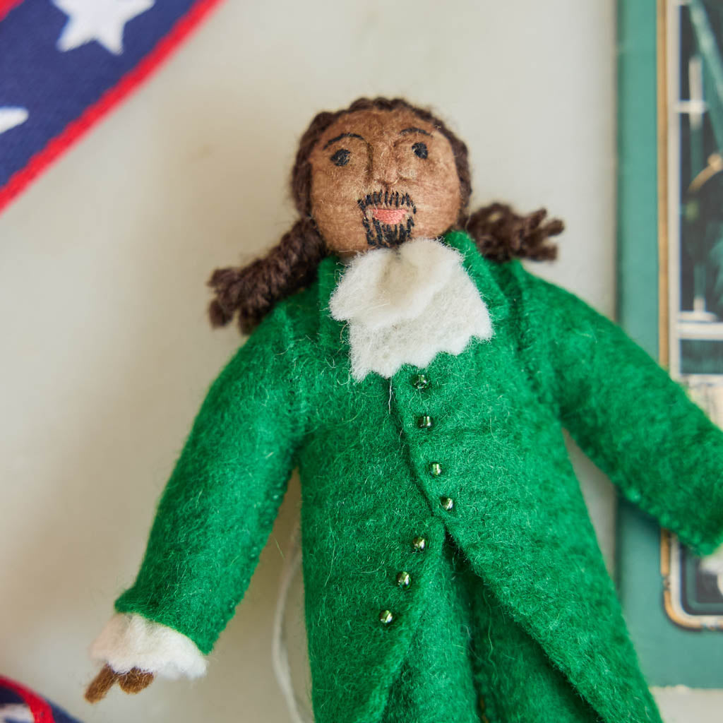 Celebrate the cultural phenomenon that brought Revolutionary history to a new generation with our handcrafted Lin-Manuel Miranda as Hamilton Ornament. Inspired by his iconic portrayal of Alexander Hamilton, this felt ornament captures the energy, creativity, and theatrical spirit of a groundbreaking American story.