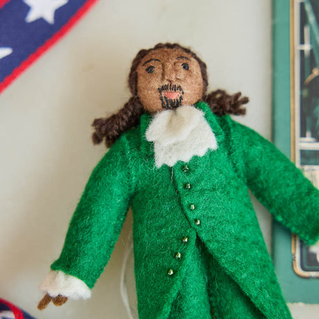 Celebrate the cultural phenomenon that brought Revolutionary history to a new generation with our handcrafted Lin-Manuel Miranda as Hamilton Ornament. Inspired by his iconic portrayal of Alexander Hamilton, this felt ornament captures the energy, creativity, and theatrical spirit of a groundbreaking American story.