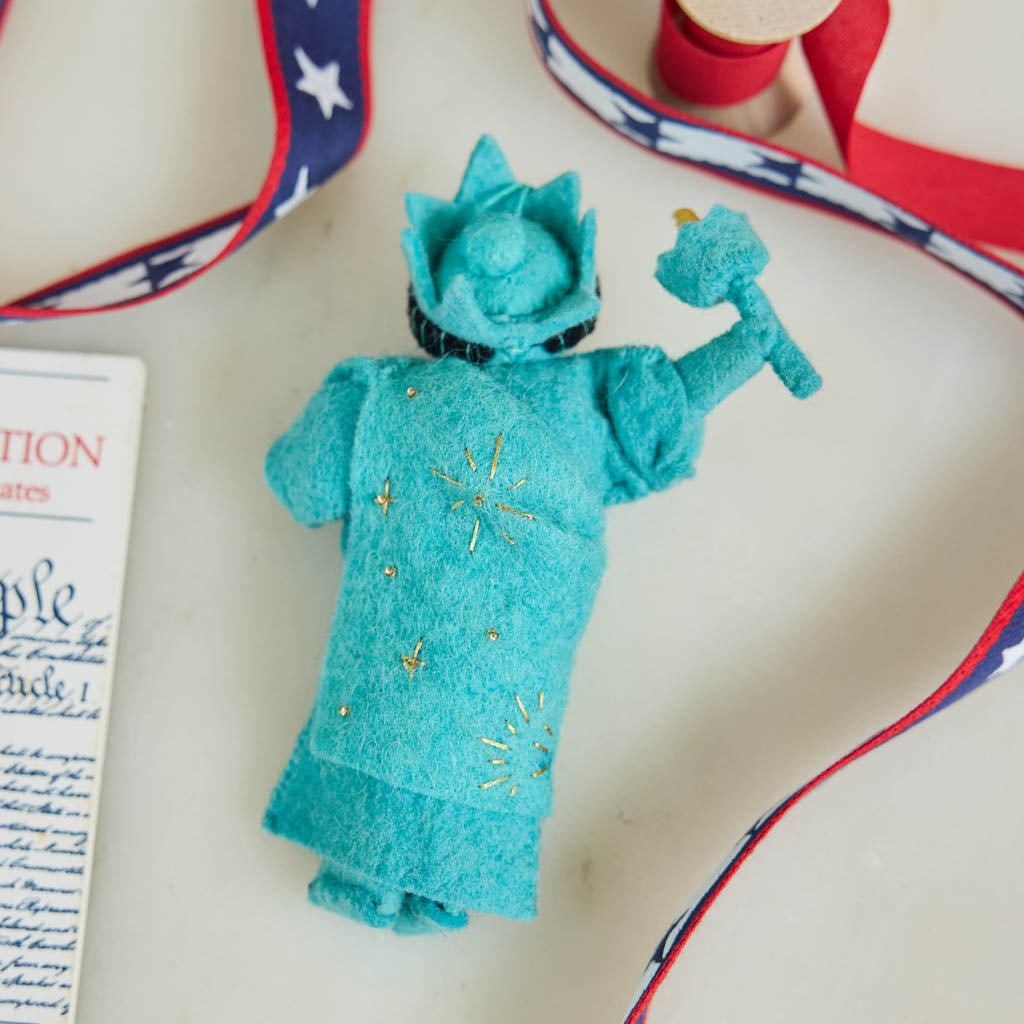 Celebrate American independence with this handcrafted July 4th Lady Liberty Ornament. Inspired by the Statue of Liberty and the founding of the United States, it's perfect for Christmas trees, Fourth of July celebrations, and Americana holiday décor.