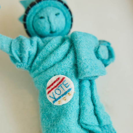 Celebrate the power of democracy with our handcrafted&nbsp;I Voted Lady Liberty Ornament from the Craftspring Semiquincentennial Collection. Inspired by the iconic Statue of Liberty, this felt ornament features Lady Liberty holding her torch and tablet while proudly displaying an “I Voted” badge—symbolizing freedom, participation, and the enduring values of American democracy.