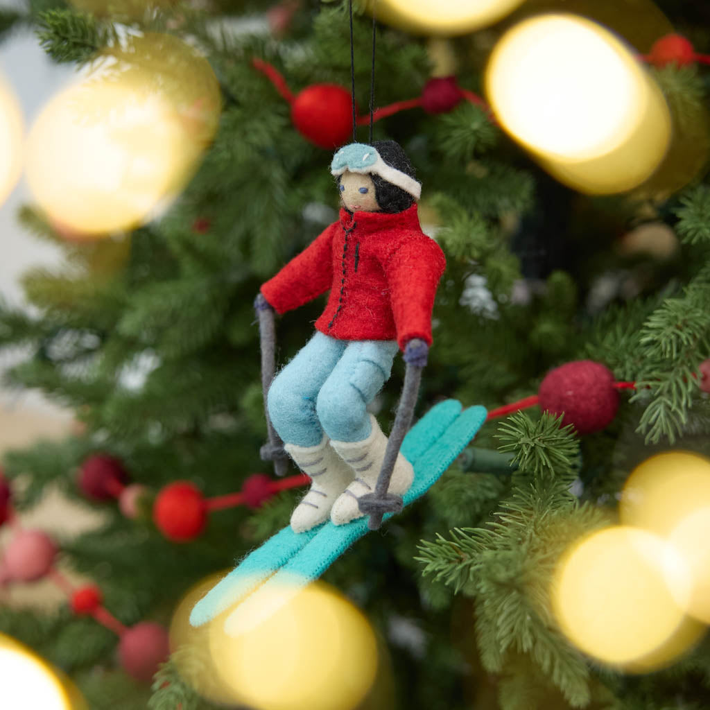 Our Alpine Skier Ornament is a handmade wool felt Christmas decoration featuring a winter sports enthusiast dressed in colorful ski gear, perfect for skiers, mountain lovers, and alpine-inspired holiday décor.