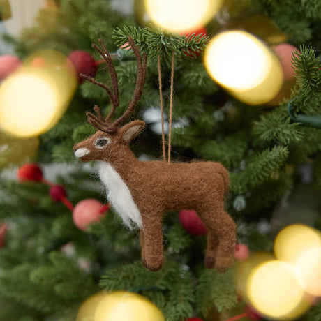 Soft, fuzzy, and full of woodland wonder, our Fuzzy Reindeer Ornament captures the quiet magic of the holiday season. With its beautiful tall antlers, sweet expression, and irresistibly fluffy coat, this darling little reindeer looks as though it has wandered straight out of an enchanted winter forest.