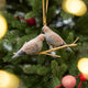 Two little doves, perched side by side. Our Mourning Doves Ornament captures one of nature’s sweetest pairings, with two beautifully hand-painted birds resting together on a delicate gold-toned metal branch.
