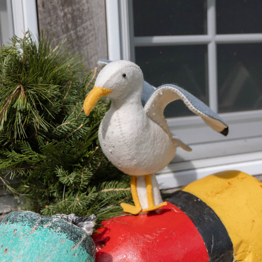 Let your holiday décor take flight with our handcrafted Seagull Tree Topper, a whimsical coastal alternative to the traditional star or angel. With wings fully outstretched, bright yellow legs, and classic black-tipped feathers, this charming seabird captures the freedom and beauty of life by the ocean.
