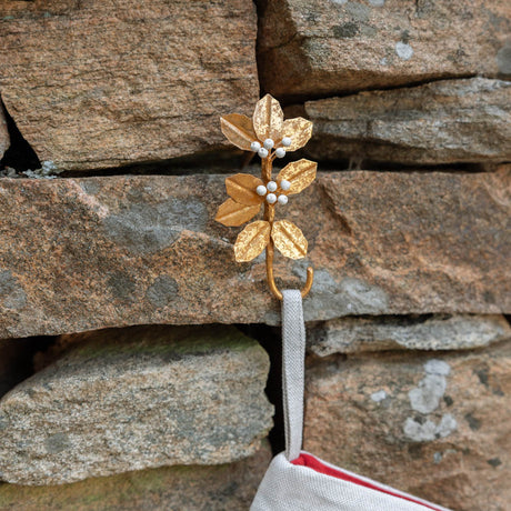 Deck the mantel! Our Holly Metal Stocking Holder turns a holiday essential into a little piece of botanical beauty, with golden holly leaves and clusters of snowy white berries handcrafted in metal.
