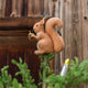 Our Squirrel Tree Topper is a handmade wool felt Christmas decoration featuring a beautifully embroidered bushy tail and golden beaded acorn, designed to perch atop your holiday tree or stand on its own as whimsical woodland décor.