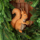 Our Squirrel Tree Topper is a handmade wool felt Christmas decoration featuring a beautifully embroidered bushy tail and golden beaded acorn, designed to perch atop your holiday tree or stand on its own as whimsical woodland décor.