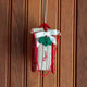 Rosebud! Our Red Flyer Sled Ornament captures the nostalgia of childhood winters and treasured holiday traditions. Inspired by classic wooden sleds, this charming keepsake features bright red runners, a cozy neutral-toned seat embroidered with "Flyer," and a festive holly sprig nestled beneath a soft white bow.