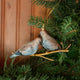 Two little doves, perched side by side. Our Mourning Doves Ornament captures one of nature’s sweetest pairings, with two beautifully hand-painted birds resting together on a delicate gold-toned metal branch.