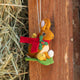 Our Brown Holiday Bunny with Chick Ornament is a sweet story of kindness and holiday cheer. Wrapped in a cozy crimson scarf adorned with felt holly and tiny red beads, this gentle brown bunny sits besides fluffy yellow chicks and a freshly hatched egg, capturing the magic of winter and the simple joy of being together.