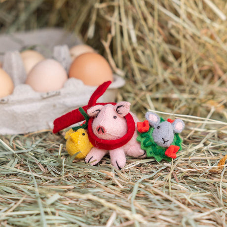  Our Festive Farm Animals Ornament brings together an adorable pink pig, a fluffy yellow chick, and a sweet gray bunny, all bundled up for the holidays. The pig wears a cozy red scarf with festive holly leaves, while the bunny sports a whimsical green holiday wreath with bright red bows. 