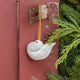 A handmade Holle Cropper Pigeon Ornament featuring a hand-painted resin bird with a distinctive puffed chest, creamy white plumage, and satin hanging ribbon.