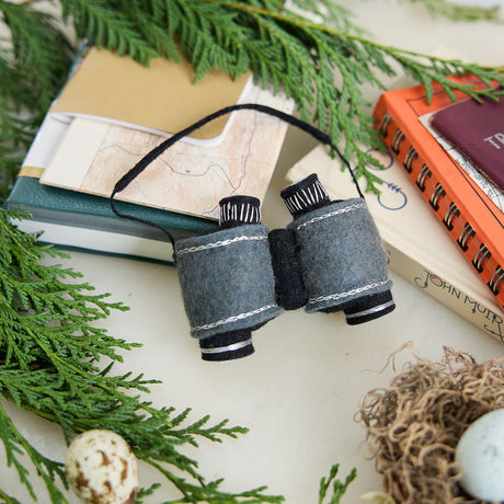 See the world through curious eyes with this hand-felted binoculars ornament, inspired by wildlife watching, outdoor exploration, and the thrill of discovering nature's hidden wonders.