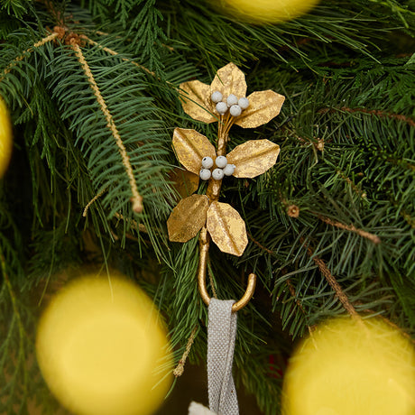 Deck the mantel! Our Holly Metal Stocking Holder turns a holiday essential into a little piece of botanical beauty, with golden holly leaves and clusters of snowy white berries handcrafted in metal.