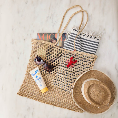 Effortlessly stylish and endlessly versatile, our Raffia Tote Bag is designed for beach days, market strolls, weekend getaways, and everyday adventures. Hand-crocheted from natural raffia fibers, this lightweight tote combines timeless coastal style with practical functionality, creating a beautiful accessory you'll reach for season after season.