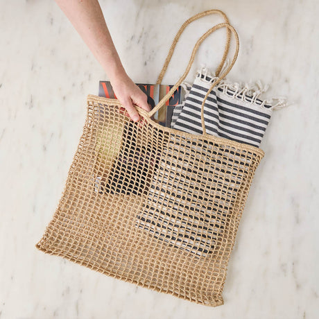 Effortlessly stylish and endlessly versatile, our Raffia Tote Bag is designed for beach days, market strolls, weekend getaways, and everyday adventures. Hand-crocheted from natural raffia fibers, this lightweight tote combines timeless coastal style with practical functionality, creating a beautiful accessory you'll reach for season after season.