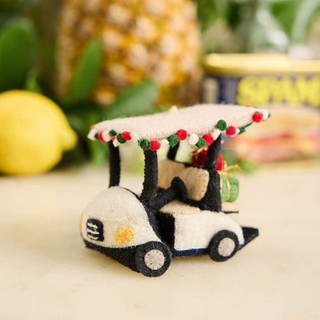Our Holiday Golf Cart Ornament is ready to roll into the season with tropical flair! Decorated with a cheerful red, green, and white garland around the roof and carrying tiny wrapped presents in the back, this festive golf cart is the perfect ride for Christmas in paradise.