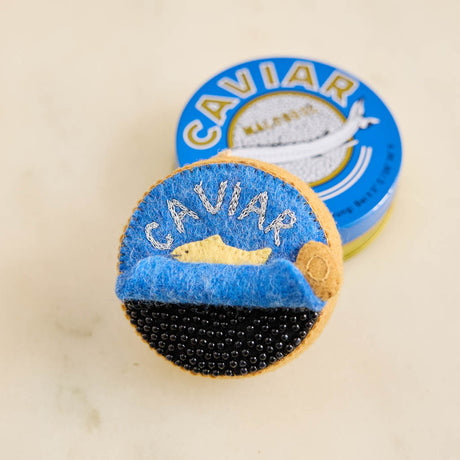 Celebrate life's finest moments with our handmade Caviar Tin Ornament, a luxurious felt keepsake inspired by gourmet entertaining, champagne toasts, and unforgettable celebrations.