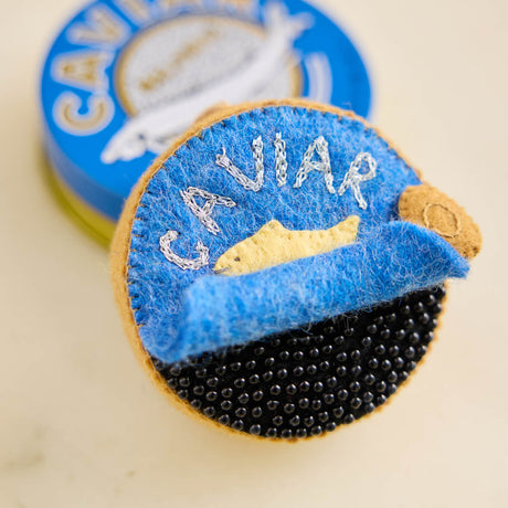 Celebrate life's finest moments with our handmade Caviar Tin Ornament, a luxurious felt keepsake inspired by gourmet entertaining, champagne toasts, and unforgettable celebrations. with tons of beaded details!