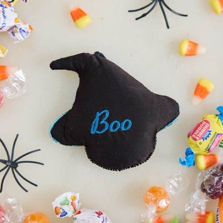 A double-sided handmade Black Cat Beaded Ornament featuring an intricately embroidered cat in a sparkling blue witch hat, with a playful “Boo” on the reverse.
