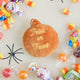 A vintage-inspired handmade beaded Jack O’Lantern Ornament featuring a smiling embroidered pumpkin face on one side and festive “Trick or Treat” detailing on the reverse.