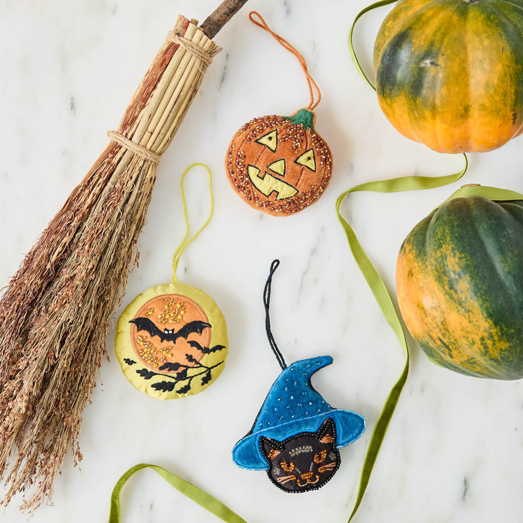 A vintage-inspired handmade beaded Jack O’Lantern Ornament featuring a smiling embroidered pumpkin face on one side and festive “Trick or Treat” detailing on the reverse.