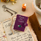 A handmade felt Book of Spells Ornament designed like a miniature mystical grimoire, complete with embroidered details, moon phases, herbal remedies, and a magical all-seeing eye.