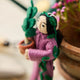 For the person who always has room for just one more plant, our Plant Parent Ornament celebrates the love, care, and wonderfully leafy obsession of keeping a home full of green things. Handcrafted from natural wool by skilled artisans, this whimsical felt ornament features a proud plant parent dressed in purple and happily surrounded by an abundance of potted greenery.