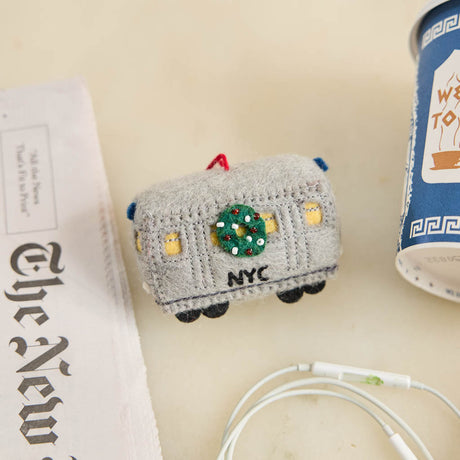 Celebrate the rhythm of New York City with our handmade NYC Subway Train Car Ornament, a charming felt keepsake inspired by the iconic subway cars that keep the city moving.