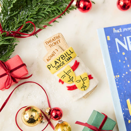Celebrate the magic of Broadway with our handmade Playbill Ornament, inspired by the iconic theater program and finished with a hidden "Bravo!" message to honor every unforgettable performance.