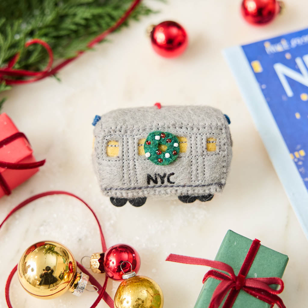 Celebrate the rhythm of New York City with our handmade NYC Subway Train Car Ornament, a charming felt keepsake inspired by the iconic subway cars that keep the city moving.