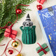 Every city has its unofficial mascot, and New York's just might be the mischievous raccoon. Meet our Trash Raccoon Ornament, peeking curiously from inside a classic green city trash can with the sweetest little face you've ever seen. Don't worry—this tiny trash panda is all charm and absolutely no trouble.